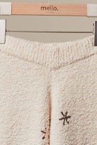 Close-up of the plush fuzzy knit waistband of the ivory Christmas Tree Sweater Pants