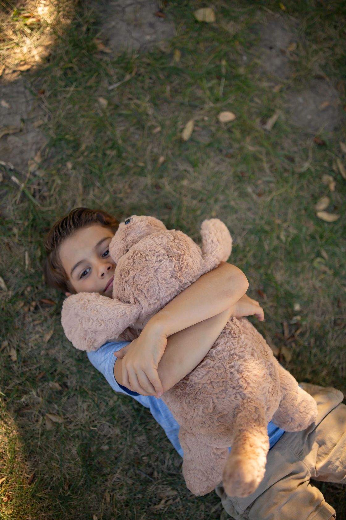 Child hugging a Chubbees 22 inch weighted plush golden retriever stuffed animal