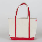 White tote bag with red handles and trim on a light gray background
