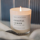 Candle labeled 'Coastal Lemon' by Sweet Water Decor on a neutral background
