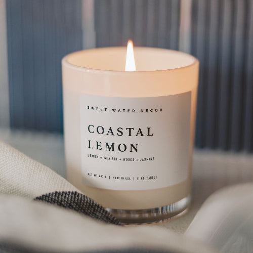Candle labeled 'Coastal Lemon' by Sweet Water Decor on a neutral background