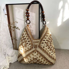 Crocheted handbag with wooden handle on a neutral background