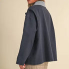 Back side view of the &merci Denim Utility Jacket in indigo showing the relaxed A-line swing shape