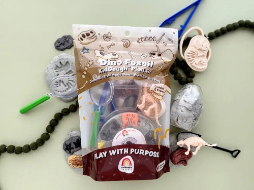 Dino Fossil Dig Kiddough play dough kit with dinosaur-themed play pieces