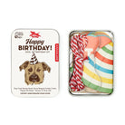 Dog birthday kit with colorful party hat, banner, and cookie cutter on a white background