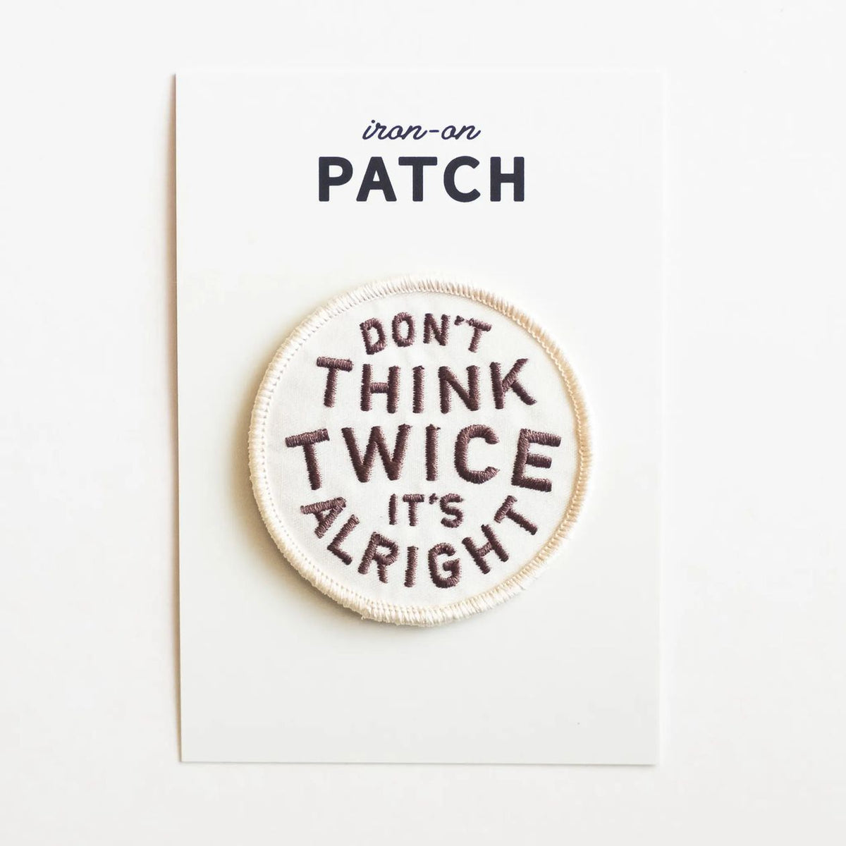 Round embroidered patch with text 'Don't think twice, it's alright' on a white background