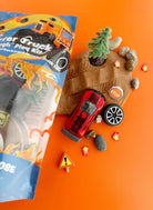 Earth Grown KidDoughs Monster Truck KidDough Play Kit with root beer scented dough, trucks and rocks on orange