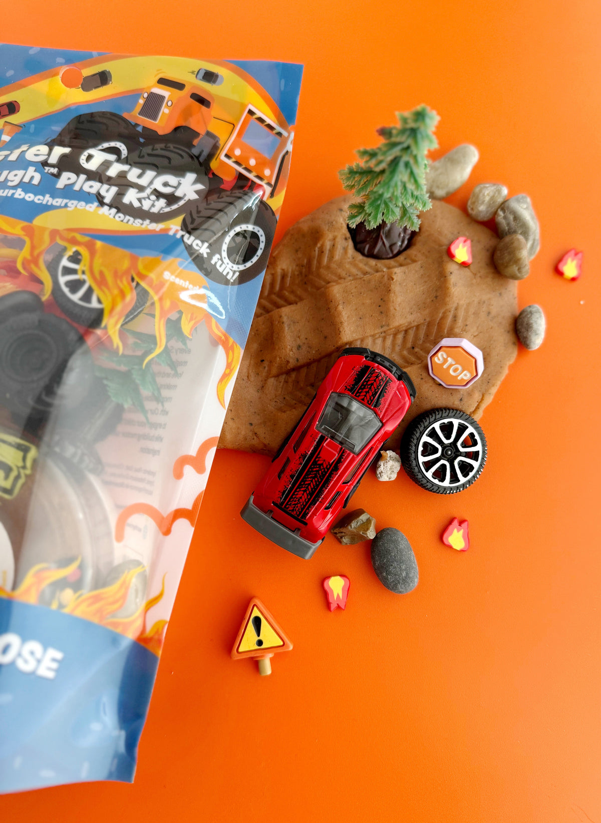 Earth Grown KidDoughs Monster Truck KidDough Play Kit with root beer scented dough, trucks and rocks on orange
