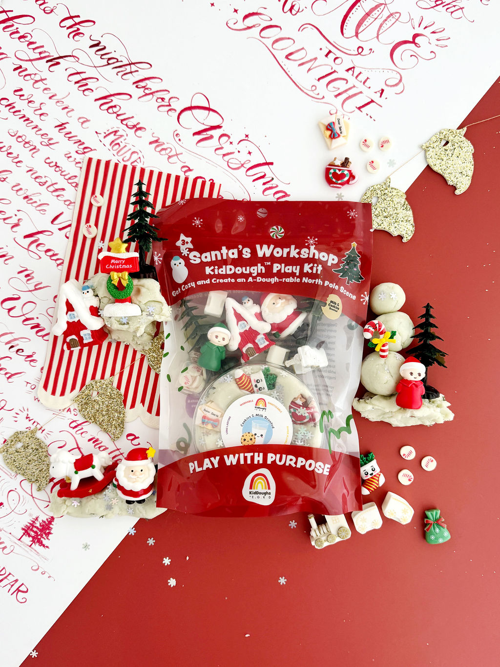Earth Grown KidDoughs Santa's Workshop KidDough Play Kit with candy, toys and play dough on a red and white holiday backdrop
