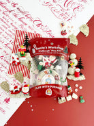 Earth Grown KidDoughs Santa's Workshop KidDough Play Kit with candy, toys and play dough on a red and white holiday backdrop