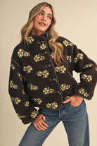 Woman wearing the &merci Floral Sherpa Jacket in brown with butter-yellow flowers and contrast piping, front view