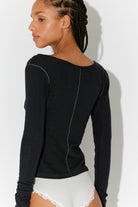Back view of the Free People End Game Pointelle Long Sleeve in black, a fitted pointelle knit