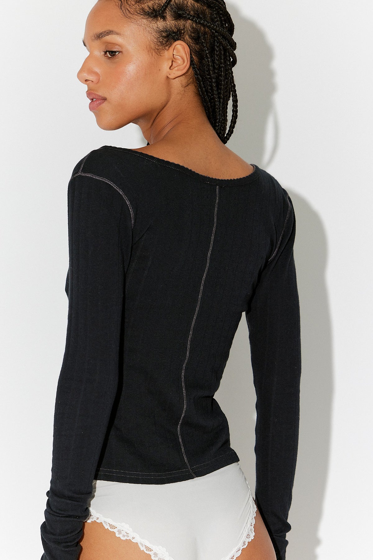 Back view of the Free People End Game Pointelle Long Sleeve in black, a fitted pointelle knit