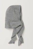 Flat lay of the Free People Extra Large Balabonnet in grey ribbed knit, showing the hood and long self-tie scarf ends