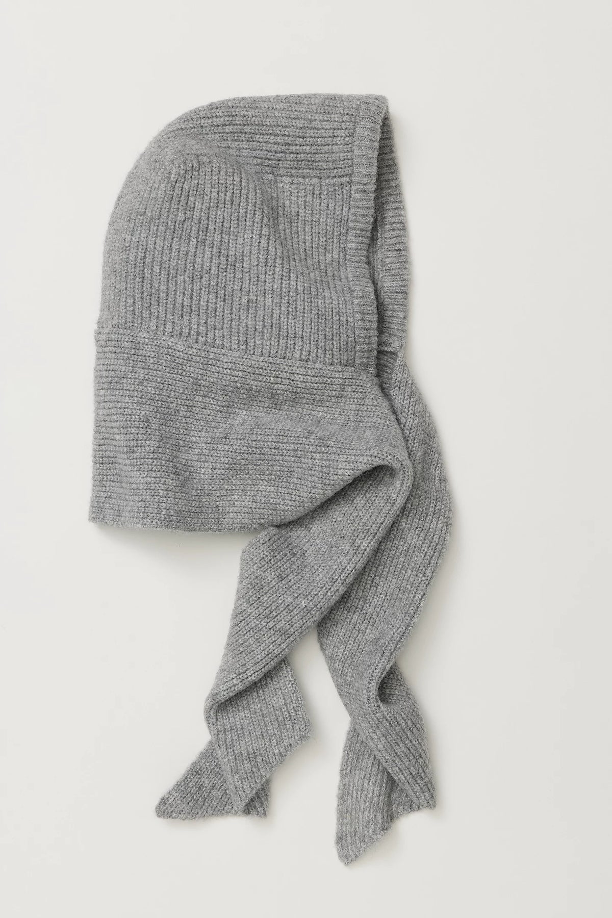Flat lay of the Free People Extra Large Balabonnet in grey ribbed knit, showing the hood and long self-tie scarf ends