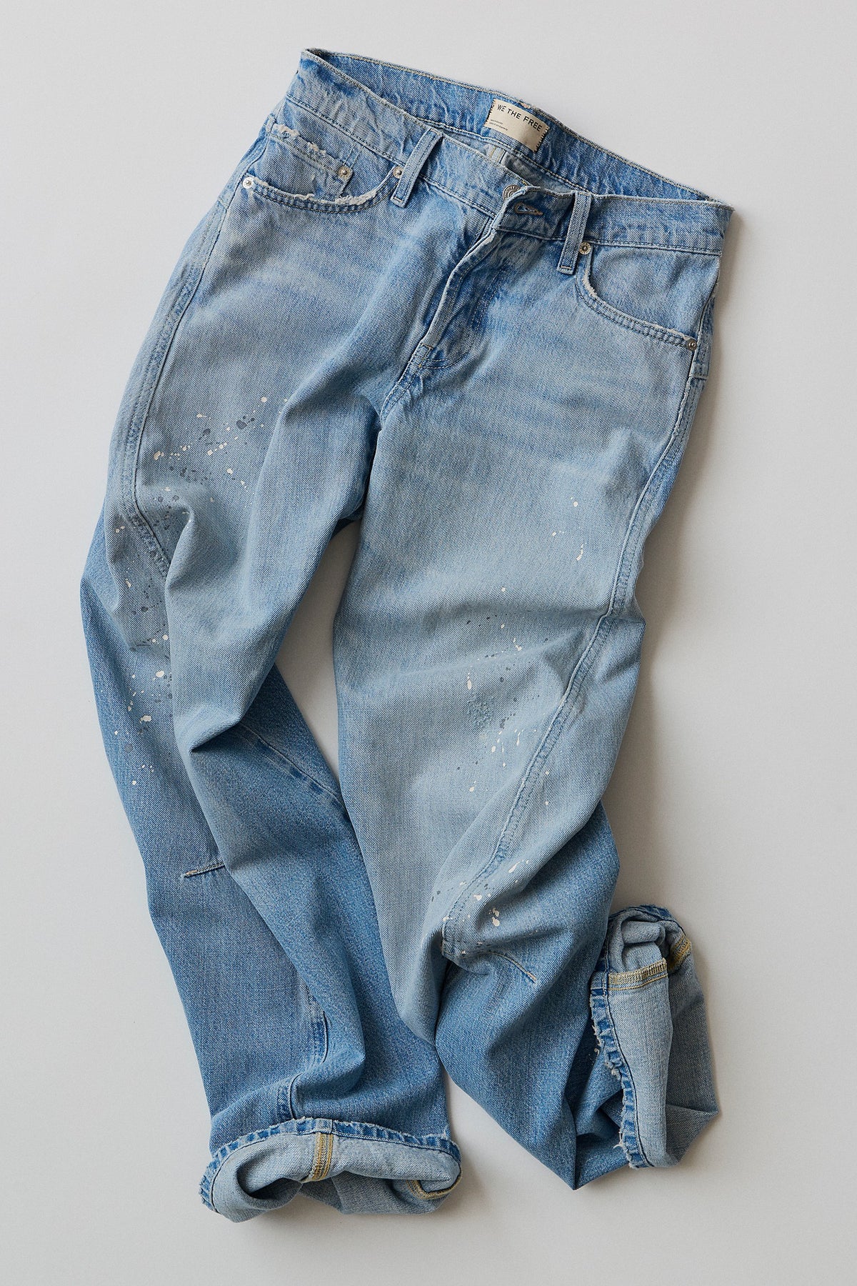 Flat lay of the Fable Low-Rise Twisted Seam Jean in Art School light wash denim