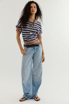 Side view of the Fable Twisted Seam Jean in Art School showing the arced barrel leg