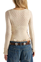 Back view of the Free People Love Cardi in winter white, showing the diamond pointelle knit and ruffle hem