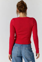 Back view of the Free People Mila Pullover in salsa red showing the fitted ribbed knit and cropped length