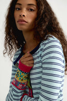 Close-up of the Free People We The Free Noa Cardi, a fitted light blue and navy striped cardigan with navy crew neck trim and pink multicolor embroidered cuffs