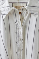 Flat view of the Free People Seaside Cotton Stripe Shirt in Ivory Combo, a pinstripe button-front with collar