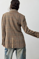 Back view of the Free People Shiloh Blazer, a relaxed brown and beige plaid wool-blend blazer with a center back vent