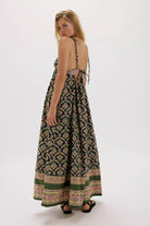Woman wearing a patterned dress on a white background