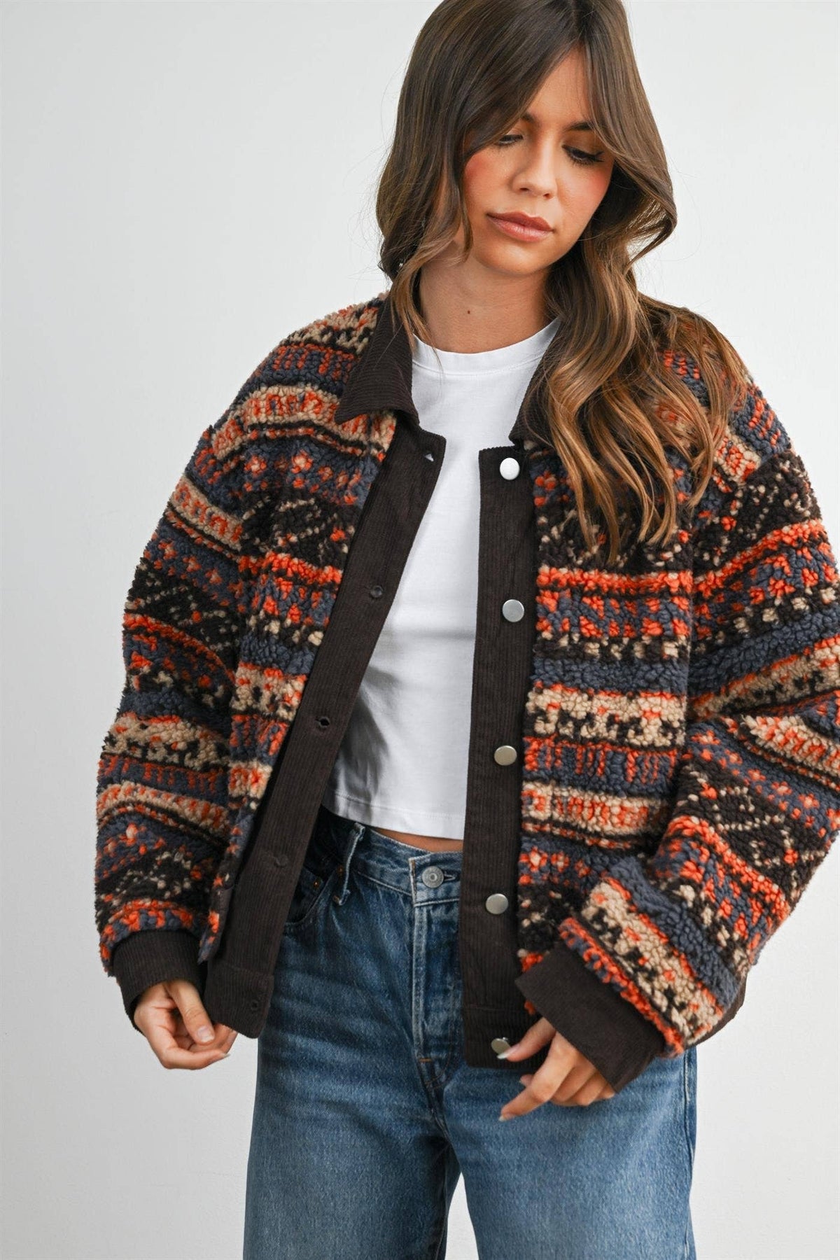 Geometric sherpa fleece jacket in brown multi, three-quarter view with hand pocket