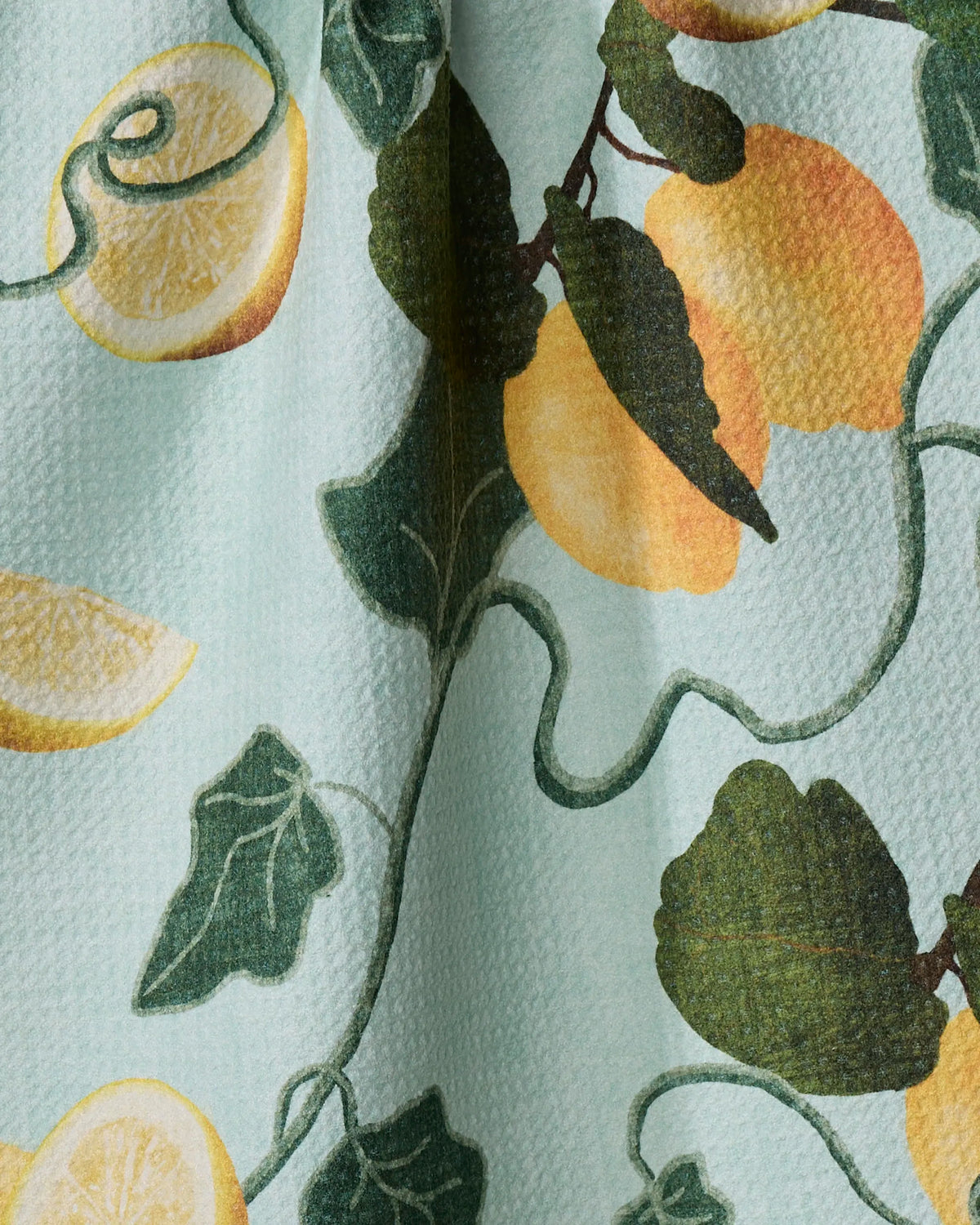 Close-up of the Geometry Amalfi Lemons tea towel lemon print and Geoweave texture