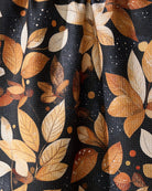 Close-up of the Geometry Botanical Wonderland tea towel orange, tan and cream leaf print on navy