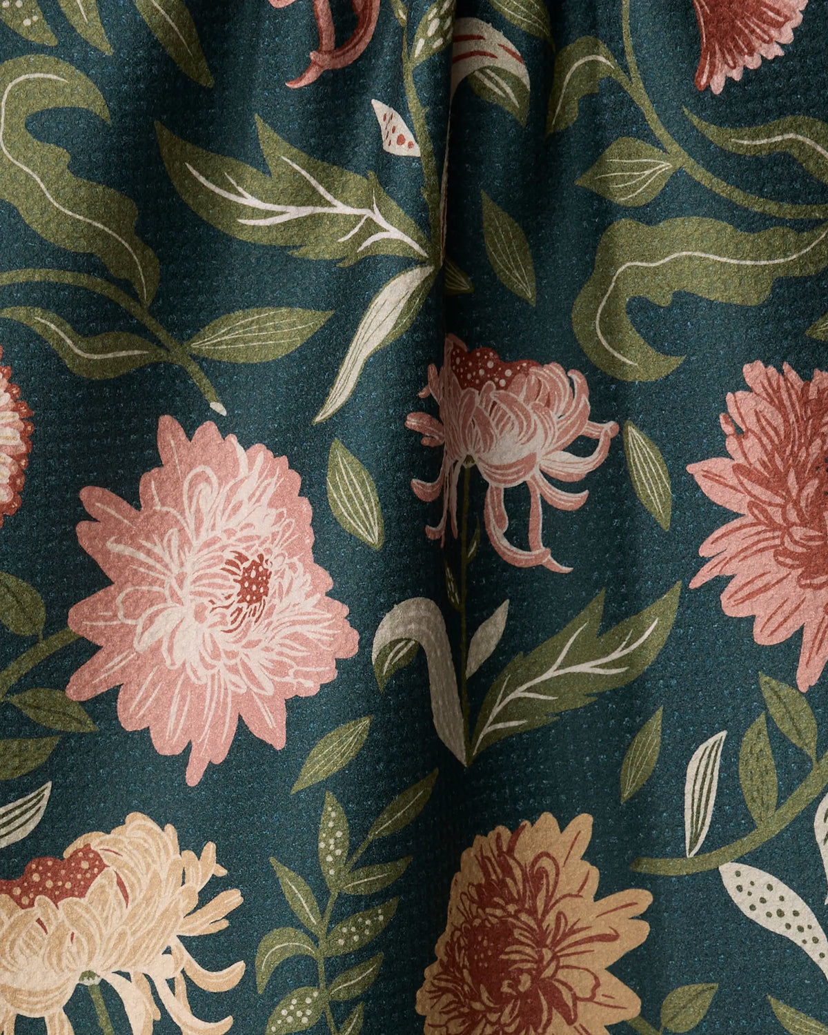 Close-up of the Geometry Chrysanthemums In November tea towel coral and blush mums on forest green