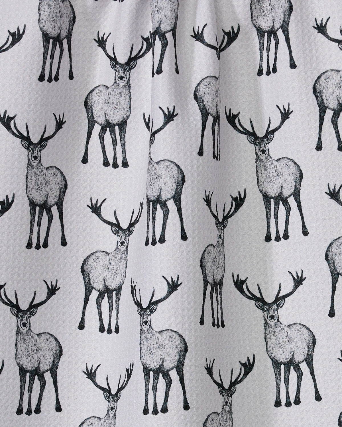 Close-up of the Geometry Hartley tea towel black stag print on white