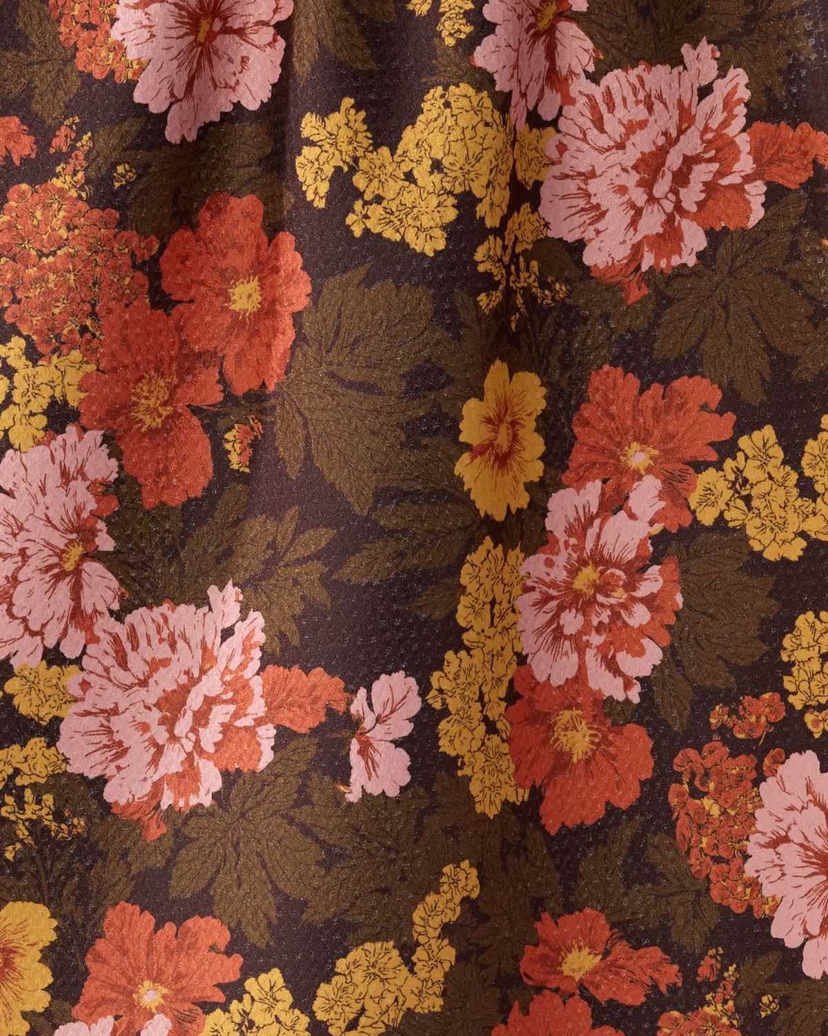 Close-up of the Geometry Mabel tea towel retro coral, pink and gold floral print on chocolate brown