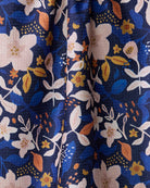 Close-up of the Geometry Nightfall Garden tea towel blush floral print on navy