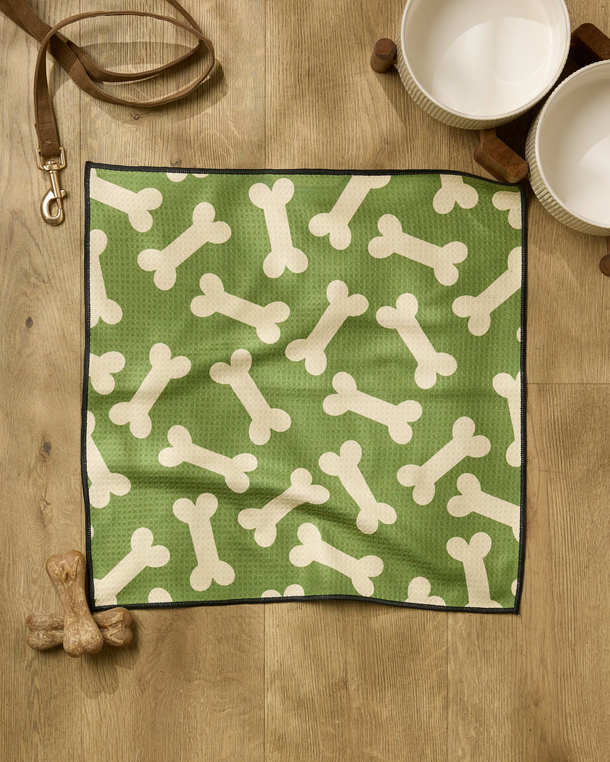 Geometry Park Run paw towel with cream dog bone print on green