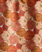 Close-up of the Geometry Tendril tea towel painterly pumpkin print in coral, rust, cream and gold