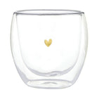 Clear glass tumbler with a gold heart on a white background