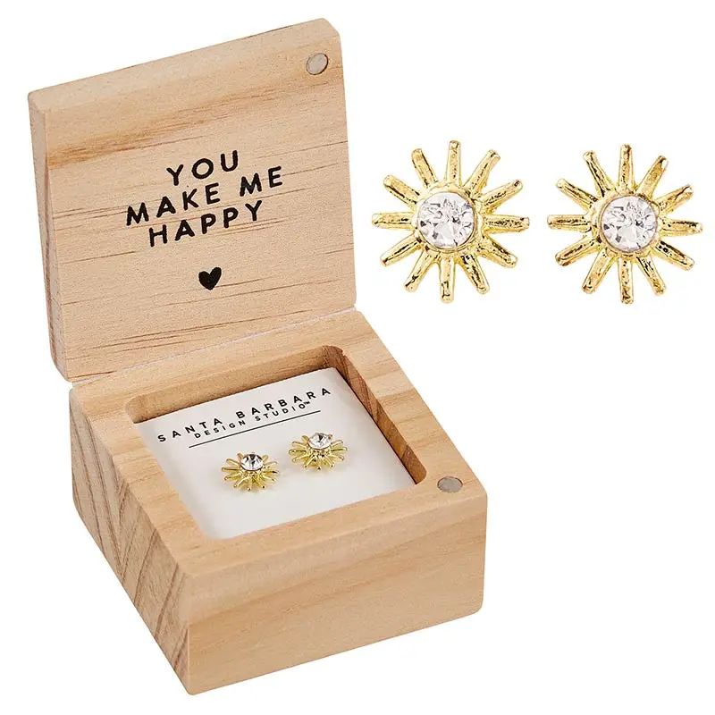 Sun-shaped earrings in a wooden box with 'You Make Me Happy' text