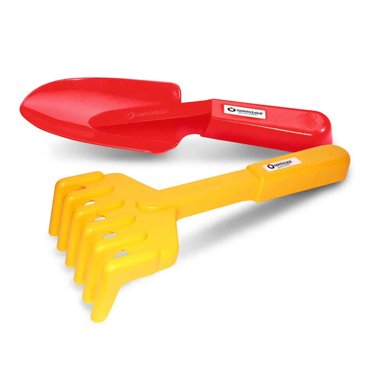 Red shovel and yellow rake on a white background