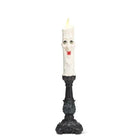 Happy Candle Halloween LED candlestick with smiling wax-drip candle on an ornate black base