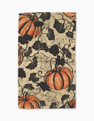 Harvest Curl tea towel with orange pumpkins and black vines on a warm parchment background
