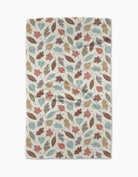 Harvest Scatter tea towel in cream with sage, teal, rust, and mauve autumn leaf print