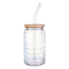 Glass tumbler with wooden lid and straw on a white background