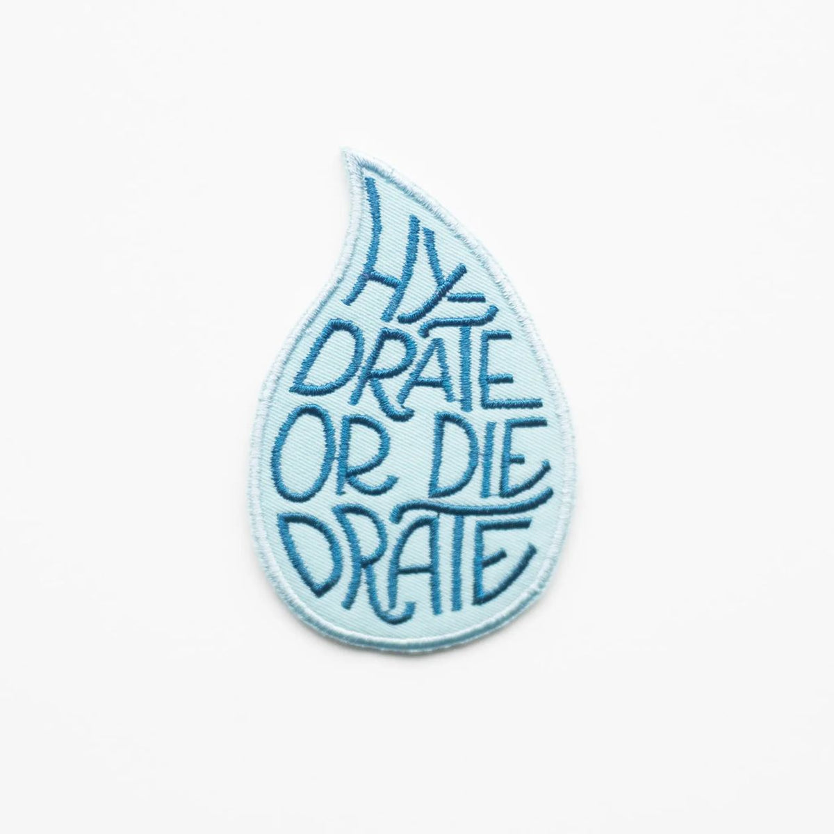Blue embroidered patch with 'Hydrate or Die' text on a white background