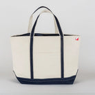 Beige tote bag with navy accents on a light gray background