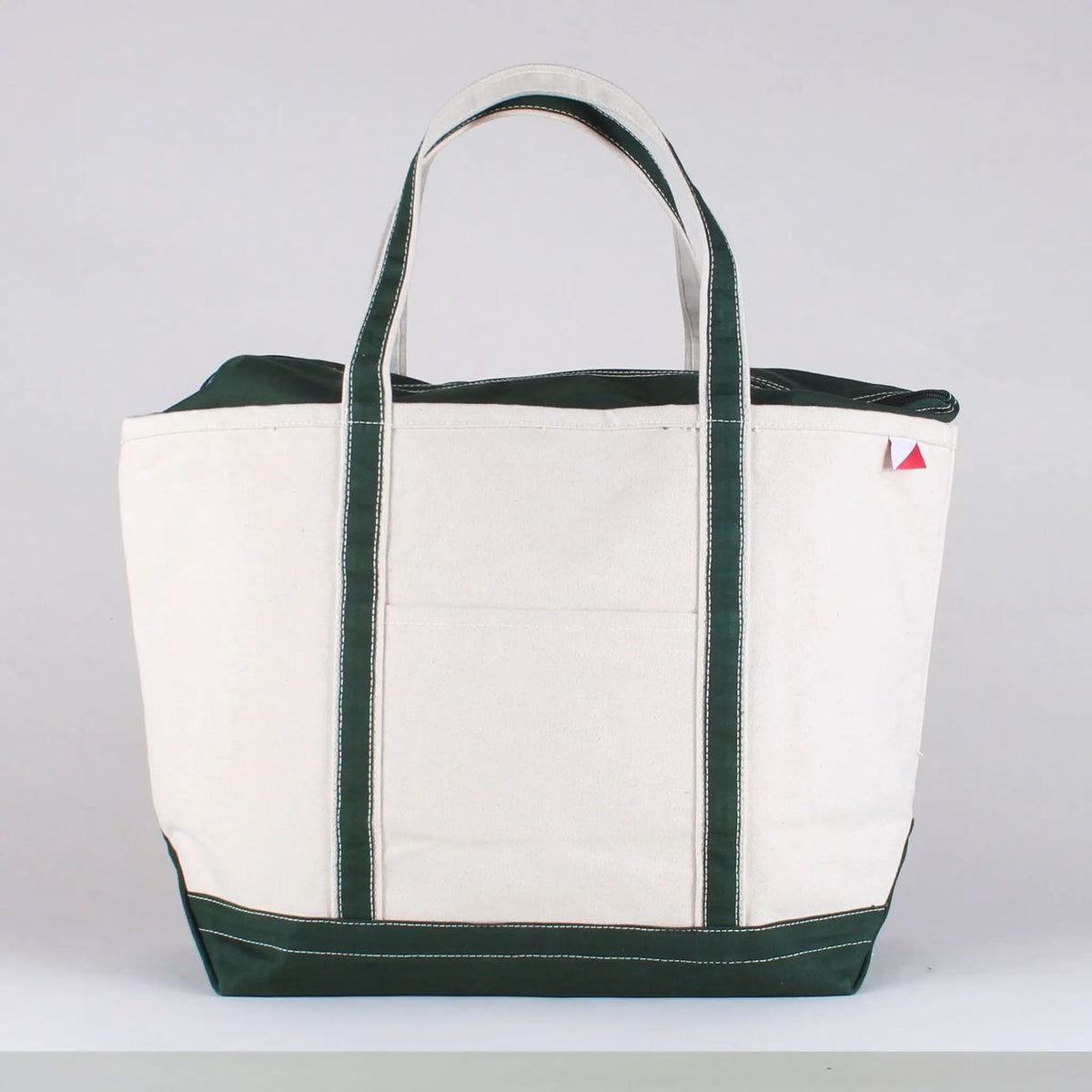 White tote bag with green trim on a white background