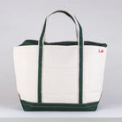 White tote bag with green trim on a white background