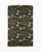 Last Seeds tea towel in deep charcoal with gray-blue and gold pumpkins, dried flowers, and small songbirds