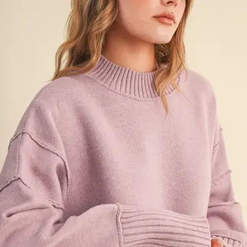 Close-up of the &merci Mock Neck Ribbed Sweater in lavender showing the ribbed mock neck and drop shoulder seam