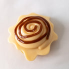 Mushmeez cinnamon roll taba squishy with layered icing swirl on a white background